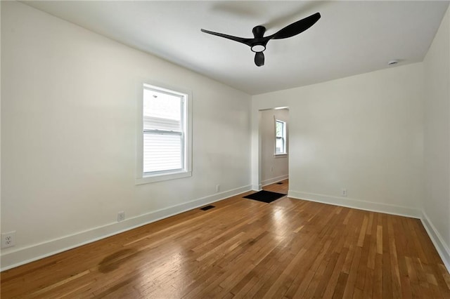 1220 E 24th Ave, Kansas City, MO 64116 - unfurnished room with a ceiling fan, baseboards, and hardwood / wood-style floors