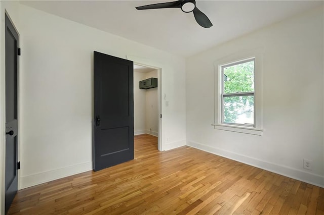 1220 E 24th Ave, Kansas City, MO 64116 - unfurnished bedroom featuring light wood-style floors, baseboards, and ceiling fan
