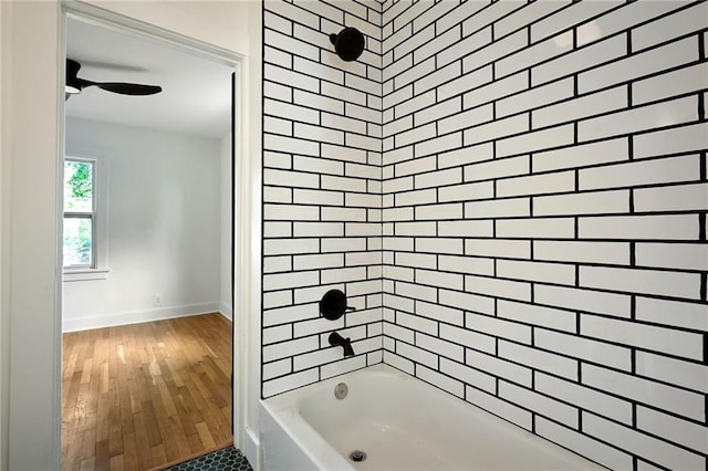 1220 E 24th Ave, Kansas City, MO 64116 - full bath with wood-type flooring, shower / tub combination, a ceiling fan, and baseboards