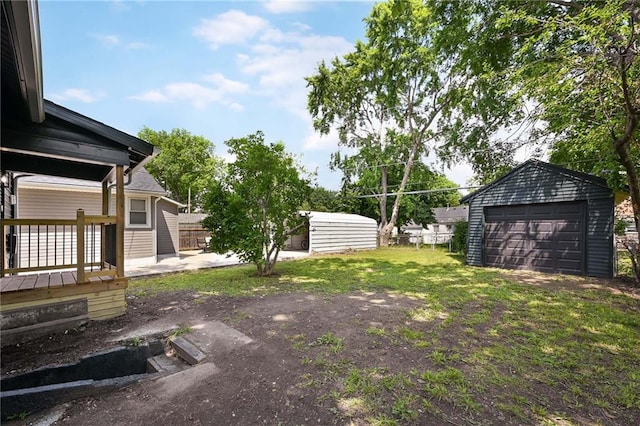 1220 E 24th Ave, Kansas City, MO 64116 - view of yard featuring an outdoor structure, a garage, and a deck