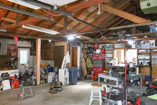 300 Brown Ave, Osawatomie, KS 66064 - garage with a garage door opener and a workshop area