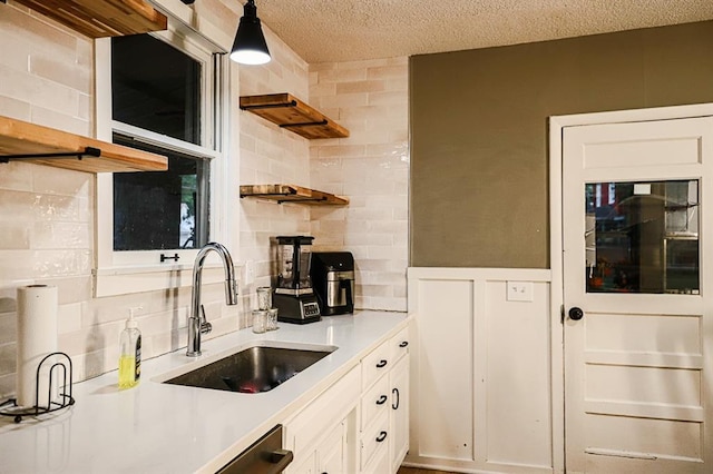 300 Brown Ave, Osawatomie, KS 66064 - kitchen featuring open shelves, decorative backsplash, white cabinets, light countertops, and a textured ceiling