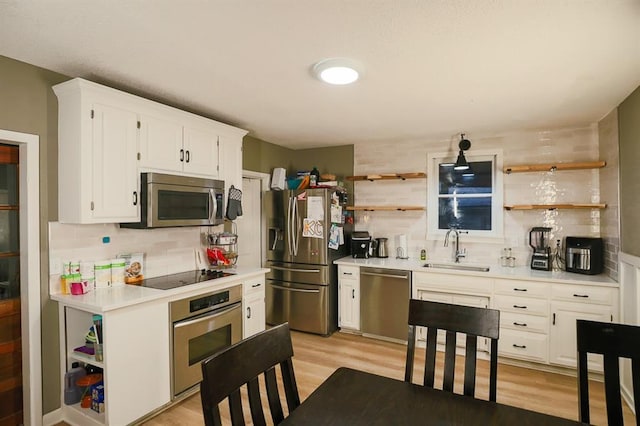 300 Brown Ave, Osawatomie, KS 66064 - kitchen with stainless steel appliances, open shelves, and decorative backsplash