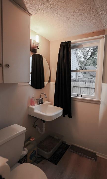 300 Brown Ave, Osawatomie, KS 66064 - bathroom featuring a textured ceiling and wood finished floors