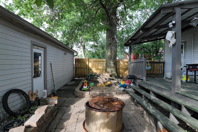 300 Brown Ave, Osawatomie, KS 66064 - view of patio / terrace featuring a fire pit and a wooden deck