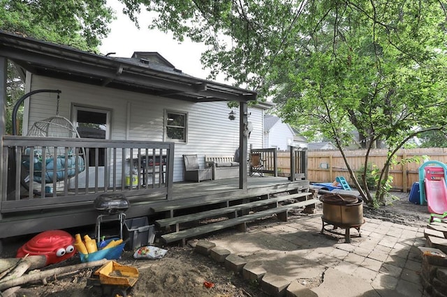300 Brown Ave, Osawatomie, KS 66064 - rear view of house with an outdoor fire pit, a patio, and a wooden deck