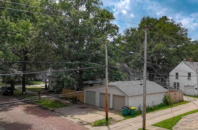 300 Brown Ave, Osawatomie, KS 66064 - view of front of property featuring an outdoor structure, roof with shingles, and a garage