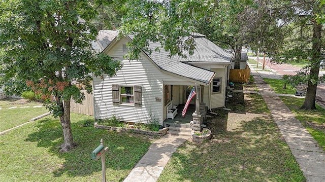 300 Brown Ave, Osawatomie, KS 66064 - bungalow-style home featuring a front yard and a shingled roof
