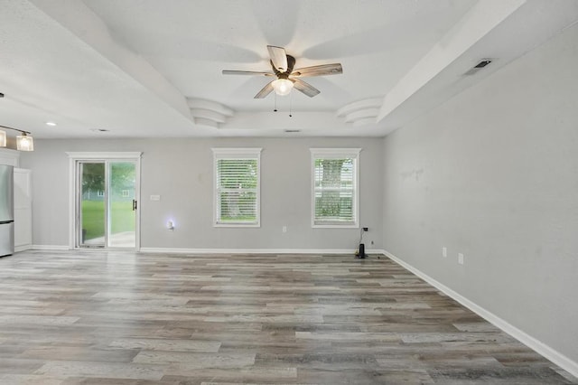 503 N Washington St, East Lynne, MO 64743 - unfurnished room with ceiling fan, baseboards, wood finished floors, recessed lighting, and a raised ceiling