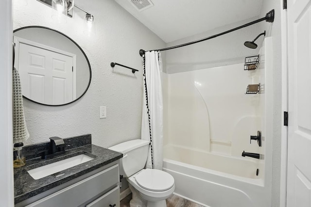 503 N Washington St, East Lynne, MO 64743 - full bathroom with vanity, shower / tub combo with curtain, toilet, and a textured wall