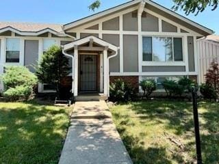 14051 Dunbar Ct, Grandview, MO 64030 - view of front of property with a front yard and brick siding