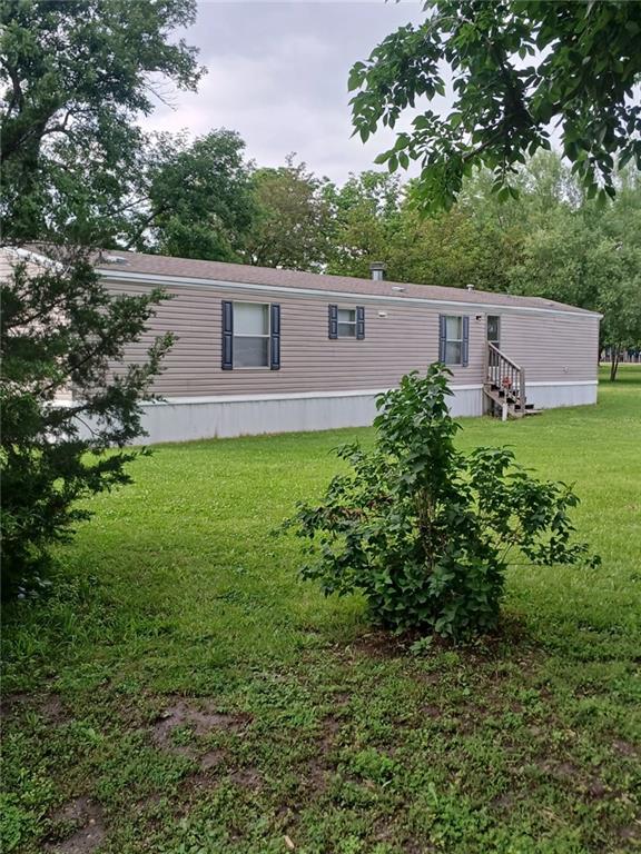504 N Locust St, Moran, KS 66755 - back of house with a lawn and entry steps