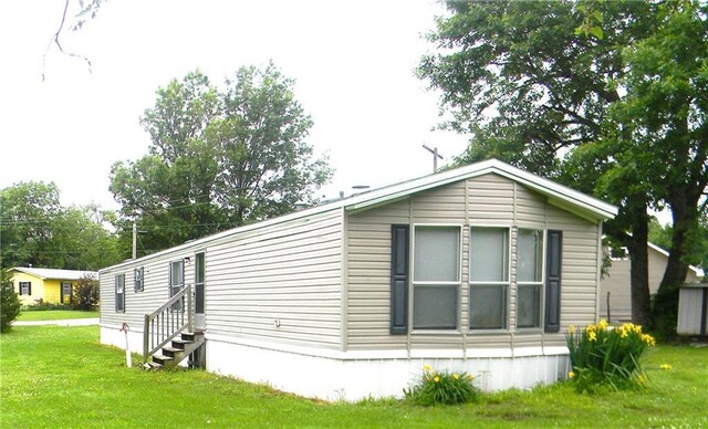 504 N Locust St, Moran, KS 66755 - view of home's exterior with a lawn and entry steps