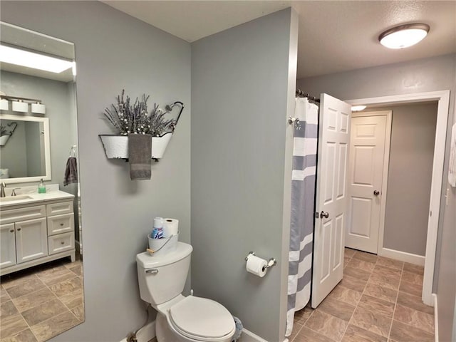 5325 Bryant Bottom Rd, Blackwater, MO 65322 - full bathroom featuring vanity, toilet, baseboards, stone finish flooring, and curtained shower