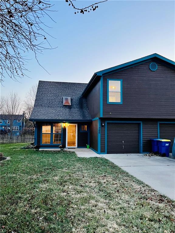 766 Spring Cir, Liberty, MO 64068 - view of front of home with driveway, an attached garage, and a shingled roof