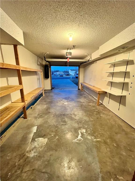 766 Spring Cir, Liberty, MO 64068 - garage featuring a garage door opener