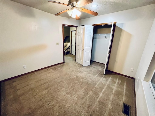 766 Spring Cir, Liberty, MO 64068 - unfurnished bedroom featuring carpet flooring, a textured ceiling, baseboards, a ceiling fan, and a closet