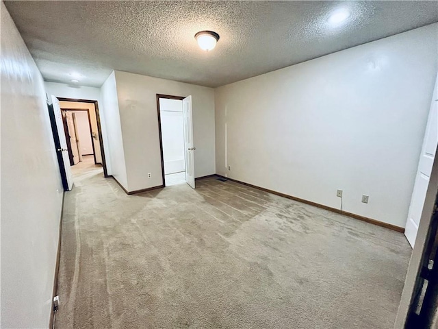 766 Spring Cir, Liberty, MO 64068 - unfurnished bedroom featuring light colored carpet, baseboards, and a textured ceiling