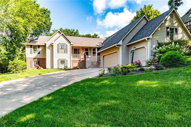 4612 Royal Birkdale Ct, Lawrence, KS 66049 - ranch-style home with concrete driveway, a garage, a front lawn, and a porch
