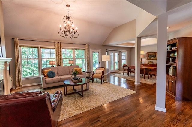 4612 Royal Birkdale Ct, Lawrence, KS 66049 - living area with dark wood-style flooring, a chandelier, lofted ceiling, and a tile fireplace