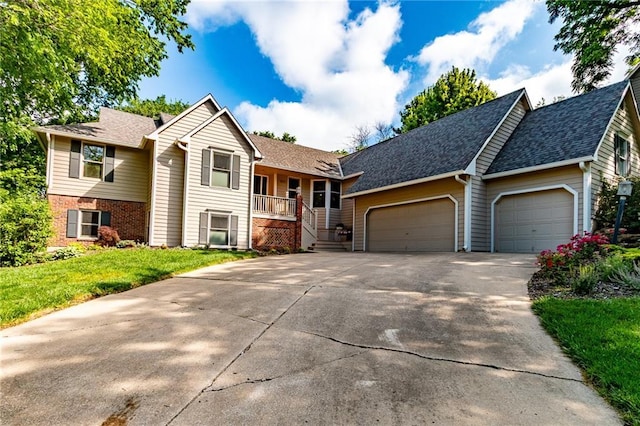4612 Royal Birkdale Ct, Lawrence, KS 66049 - view of front facade featuring a garage, driveway, a front lawn, and a shingled roof