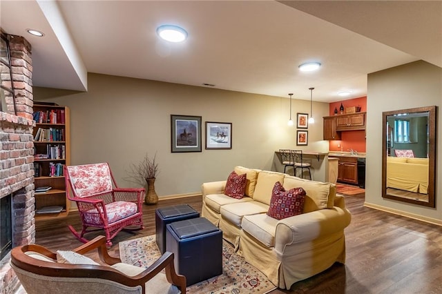 4612 Royal Birkdale Ct, Lawrence, KS 66049 - living room with a brick fireplace, wood finished floors, baseboards, and recessed lighting