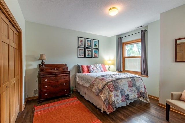 4612 Royal Birkdale Ct, Lawrence, KS 66049 - bedroom featuring dark wood-style flooring, a closet, and baseboards