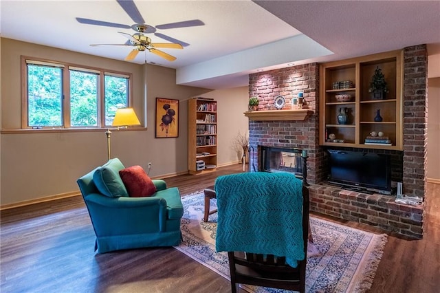 4612 Royal Birkdale Ct, Lawrence, KS 66049 - living room with a brick fireplace, wood finished floors, baseboards, and a ceiling fan