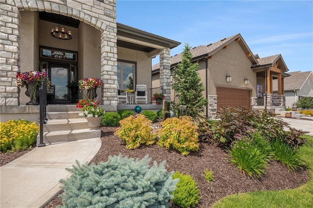 15278 W 173rd St, Olathe, KS 66062 - view of exterior entry featuring stone siding, stucco siding, a porch, and an attached garage