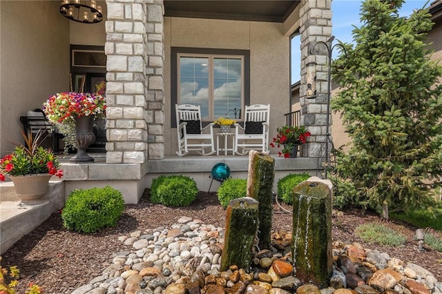 15278 W 173rd St, Olathe, KS 66062 - property entrance featuring covered porch, stucco siding, and stone siding