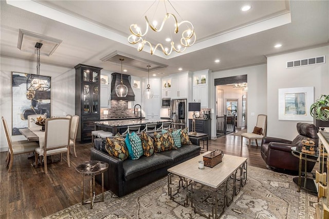 15278 W 173rd St, Olathe, KS 66062 - living area featuring dark wood finished floors, a chandelier, a raised ceiling, and recessed lighting