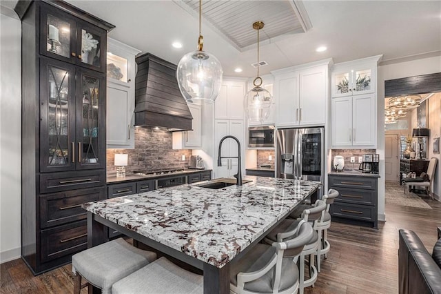 15278 W 173rd St, Olathe, KS 66062 - kitchen with stainless steel appliances, custom exhaust hood, white cabinetry, a kitchen bar, and recessed lighting