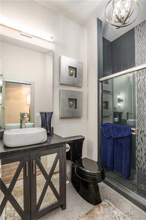 15278 W 173rd St, Olathe, KS 66062 - bathroom featuring a chandelier, a stall shower, and vanity