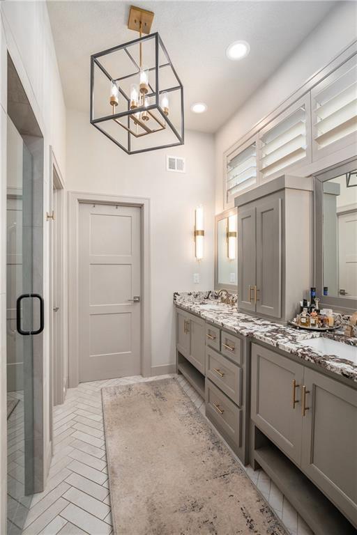 15278 W 173rd St, Olathe, KS 66062 - full bath with double vanity, a stall shower, a chandelier, and recessed lighting