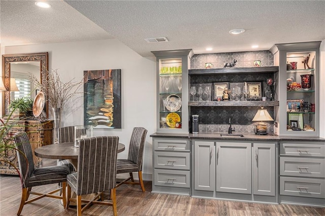 15278 W 173rd St, Olathe, KS 66062 - indoor wet bar featuring wood finished floors and a textured ceiling