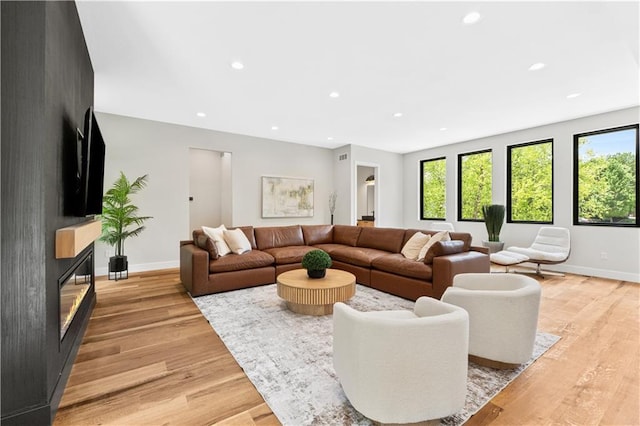 6111 Persimmon Ct, Parkville, MO 64152 - living room featuring light wood-type flooring, plenty of natural light, recessed lighting, and a large fireplace