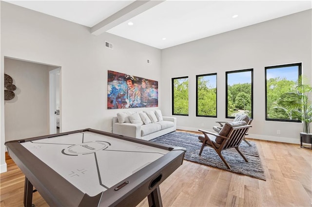 6111 Persimmon Ct, Parkville, MO 64152 - recreation room featuring light wood-style flooring, recessed lighting, baseboards, beamed ceiling, and a towering ceiling