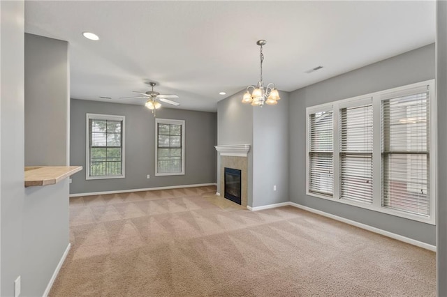 5245 Overland Dr, Lawrence, KS 66049 - unfurnished living room featuring light carpet, baseboards, ceiling fan, recessed lighting, and a tile fireplace