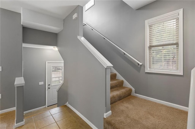5245 Overland Dr, Lawrence, KS 66049 - entrance foyer featuring tile patterned flooring, stairway, and baseboards