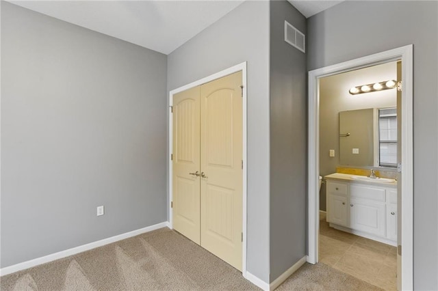 5245 Overland Dr, Lawrence, KS 66049 - unfurnished bedroom featuring a sink, baseboards, a closet, and light colored carpet