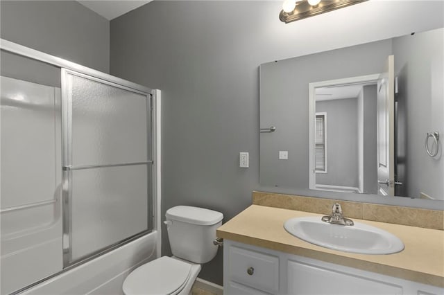 5245 Overland Dr, Lawrence, KS 66049 - full bath with toilet, vanity, and shower / bath combination with glass door