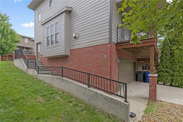 5245 Overland Dr, Lawrence, KS 66049 - view of property exterior featuring brick siding, a yard, a garage, and concrete driveway