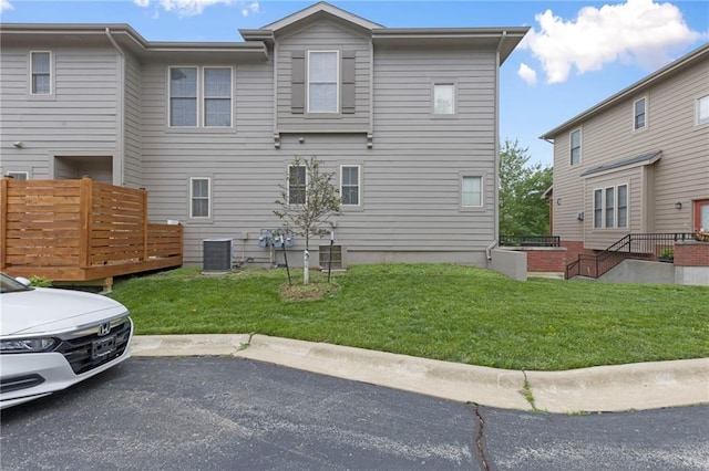 5245 Overland Dr, Lawrence, KS 66049 - view of home's exterior with cooling unit, a yard, and a deck