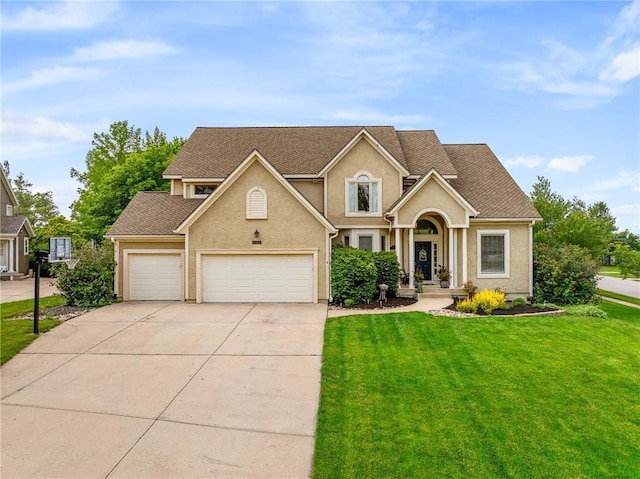 15998 Overbrook Ln, Overland Park, KS 66224 - traditional-style home with stucco siding, driveway, a front yard, and an attached garage