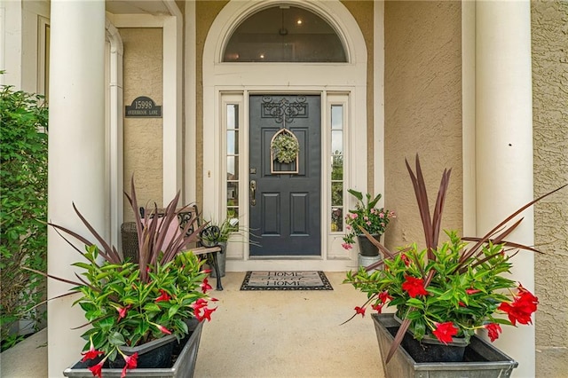 15998 Overbrook Ln, Overland Park, KS 66224 - view of exterior entry with stucco siding and covered porch