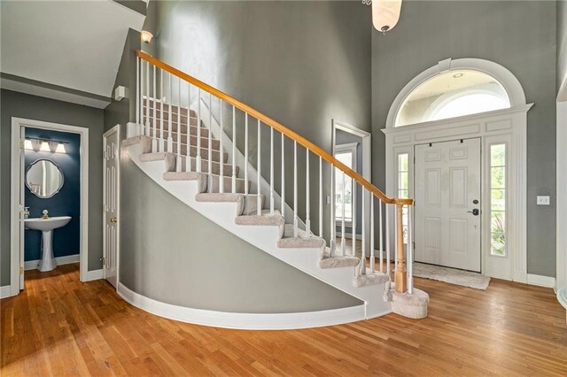 15998 Overbrook Ln, Overland Park, KS 66224 - foyer with stairs, wood finished floors, and a high ceiling