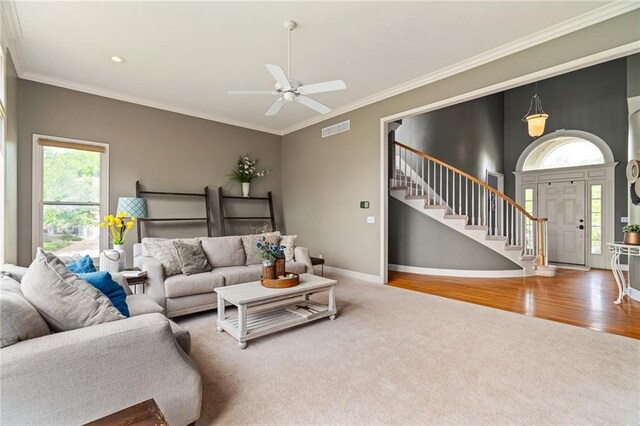 15998 Overbrook Ln, Overland Park, KS 66224 - carpeted living area with stairway, a ceiling fan, ornamental molding, wood finished floors, and recessed lighting
