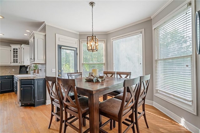 15998 Overbrook Ln, Overland Park, KS 66224 - dining area featuring plenty of natural light, a chandelier, light wood-type flooring, ornamental molding, and recessed lighting