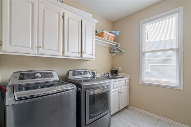 15998 Overbrook Ln, Overland Park, KS 66224 - washroom featuring washer and dryer, cabinet space, and light tile patterned floors