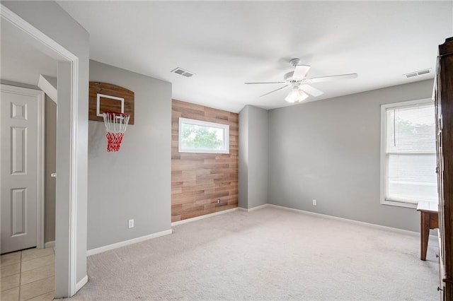 15998 Overbrook Ln, Overland Park, KS 66224 - spare room with ceiling fan, light carpet, and wood walls